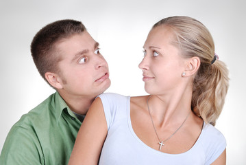 young couple looking surprisely at each other