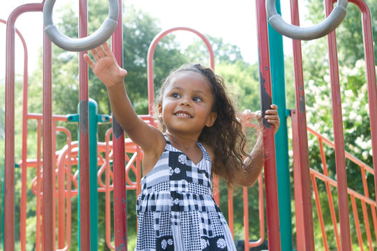 A beautiful mixed race child enjoying the playground