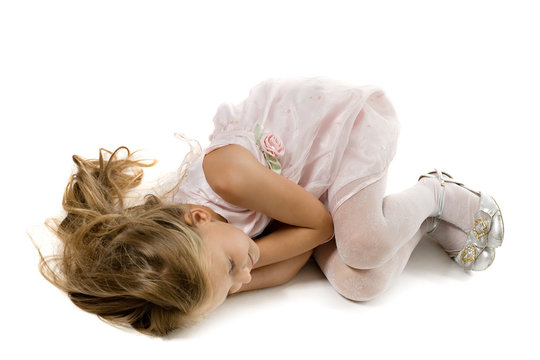 small princess with long hair sleeps on a floor