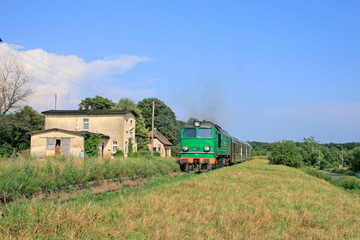 Fototapeta na wymiar Passenger train starting from the small station