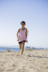 Smiling Girl Running on beach