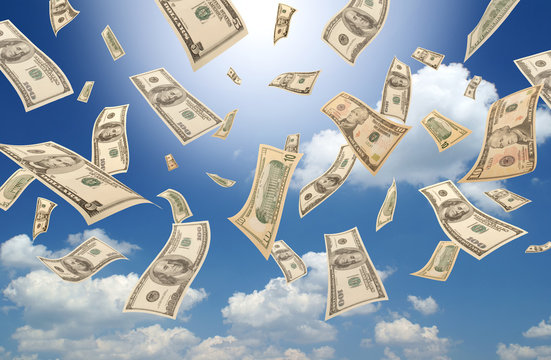 Falling dollars (sunny sky background)