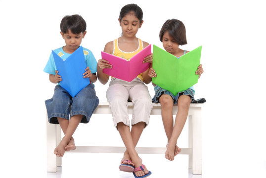 Brother and two sister reading books