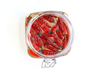 organic red chili in a jar with oil