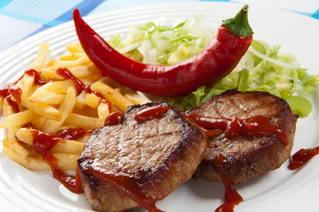 Grilled meat and, fries and  vegetable salad