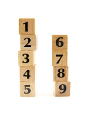stacked wooden blocks with numbers over white background