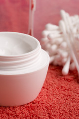 closeup of facial cream and cotton pads