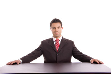 Young business man on a desk, isolated on white