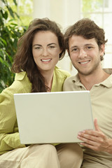Couple using laptop