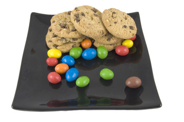 sweets and cookies on plate isolated on white background
