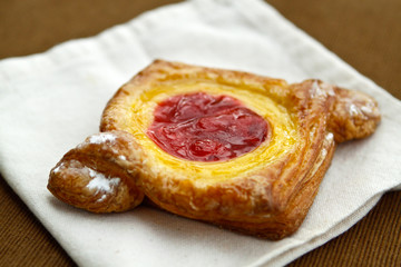 A delicious cherry danish on a white napkin