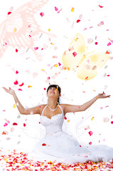 Obraz na płótnie Canvas Cute bride throws rose petals and butterflys