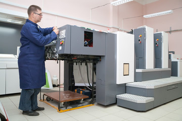 Printer working at his new offset machine