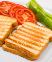 Delicious toasts with sliced tomatoes and green peppers