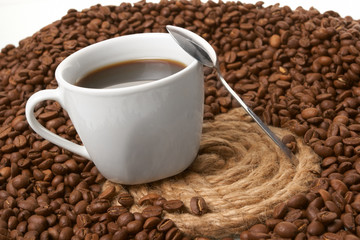 Cup with coffee, costing on coffee grain