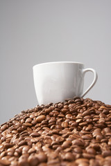 Cup with coffee, costing on coffee grain