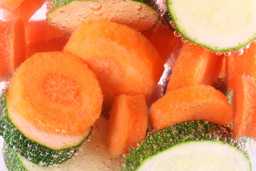 Carrots and courgettes in water cooking