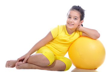 Fototapeta na wymiar Little beautiful girl in yellow with yellow ball