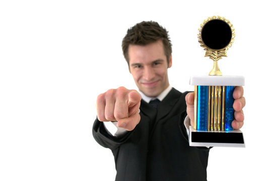Successful businessman holding a trophy