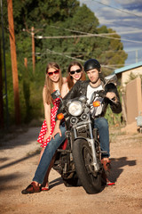 Fototapeta na wymiar Trio posing on motorcycle