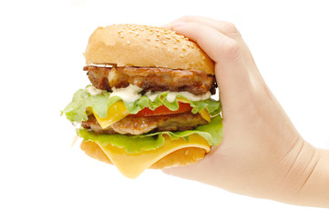 Hamburger in a hand isolated on white