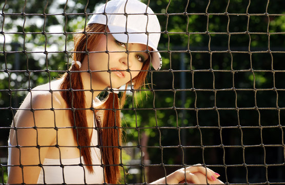 woman tennis player sitting behind the net