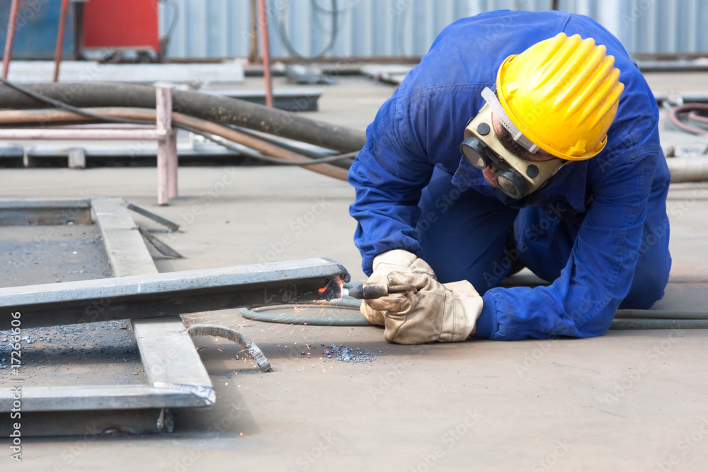 Wall mural welder with protective mask welding metal and sparks