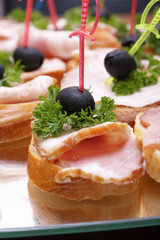 Ham sandwiches with olives and greens