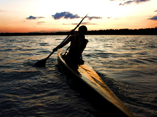 kayaker against sunset