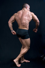 a muscular man posing artistic, back double biceps