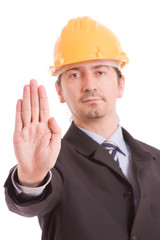 Engineer with yellow hat making stop sign