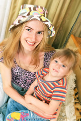 Mother and little girl on her knees