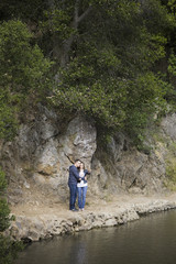 Couple Standing on Side of Lake