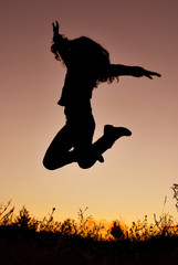 silhouette of young woman jumping