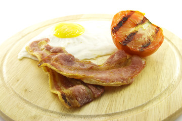 Bacon, Eggs and Tomato on Wooden Plate