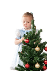 Girl decorates a Christmas tree