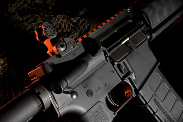 assault rifle on a dark background and rim lighting coming from the side