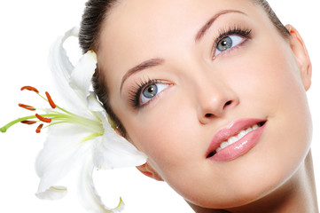 Healthy skin of beautiful woman face with a flower