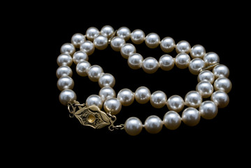 Pearls necklace on black background