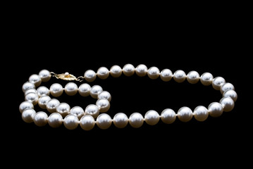 Pearls necklace on black background