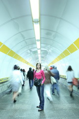 Subway - young woman standing in subway corridor