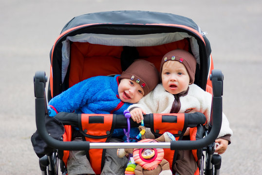 Cute Twin Boys Outdoors In The Stroller