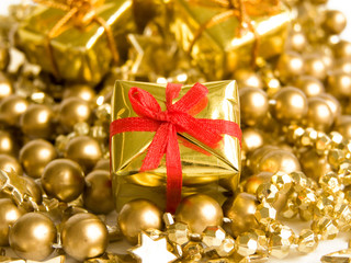 Small golden gift with red ribbon. Shallow DOF.