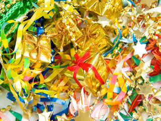 Small golden gifts around colored confetti. Shallow DOF.
