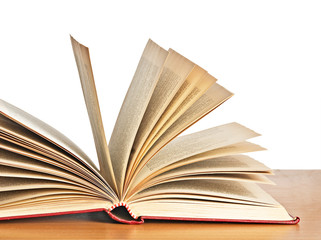 Open book on desk isolated on white background