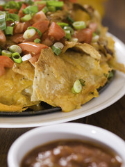 nachos with salsa on table