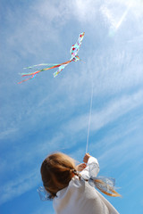 child flying a kite