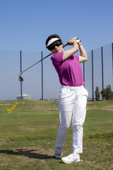 Young Woman Practicing Her Golf Swing
