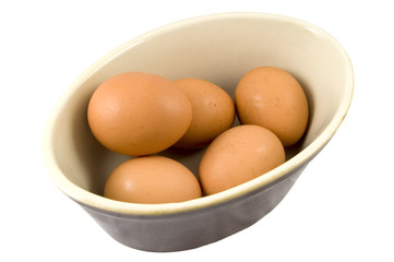 high view of eggs in dish isolated on white background