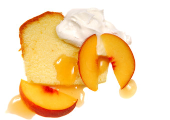 Fototapeta na wymiar Pound cake with whipped cream and peaches
